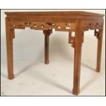 A 20th Century Chinese hardwood dining table of square form, with a foliate carved frieze, on square