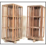 An unusual pair of 20th century hardwood Industrial style large revolving bookcases. Each on splayed