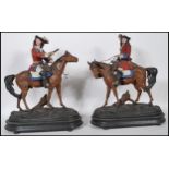 A pair of early 20th Century cold painted spelter figures of soldiers on horseback. The soldiers