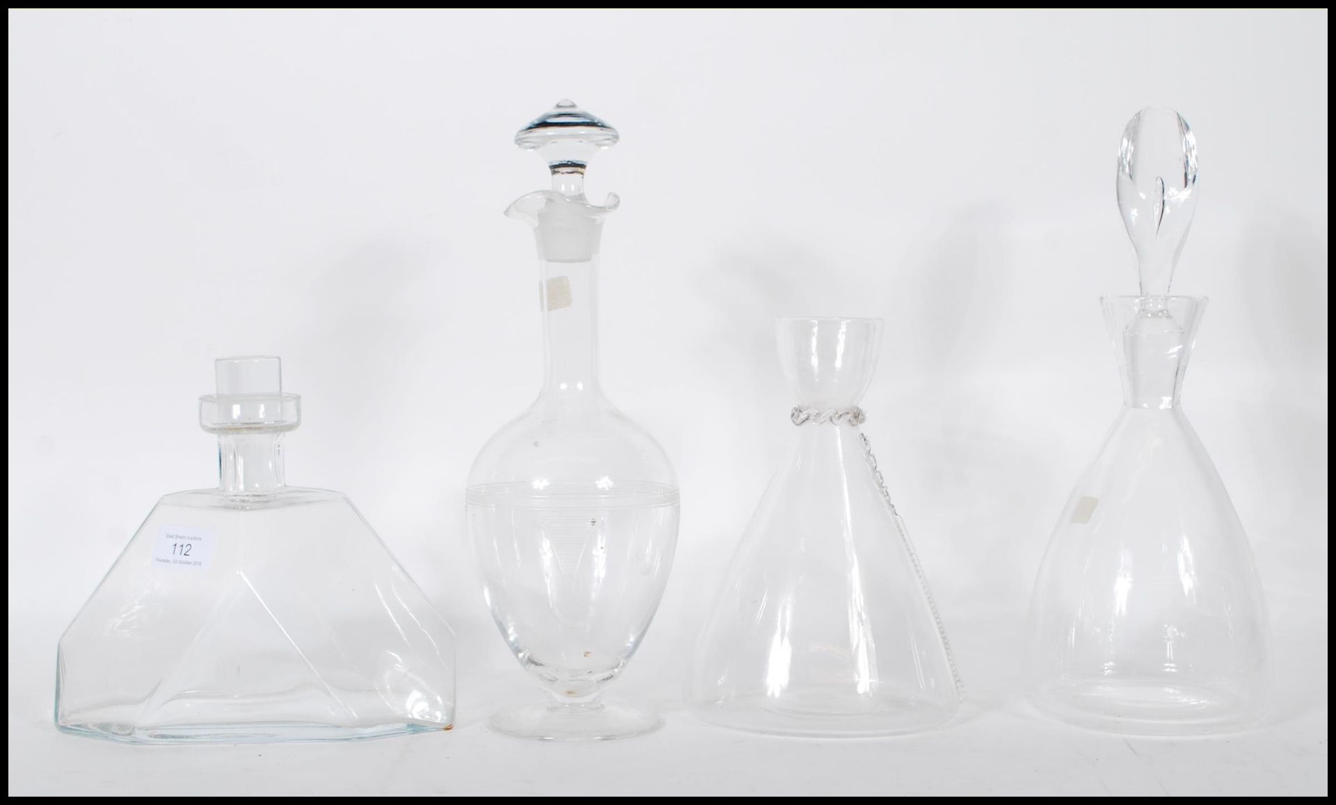 A selection of mid 20th Century glass decanters to include a geometric form decanter of wide