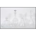 A selection of mid 20th Century glass decanters to include a geometric form decanter of wide