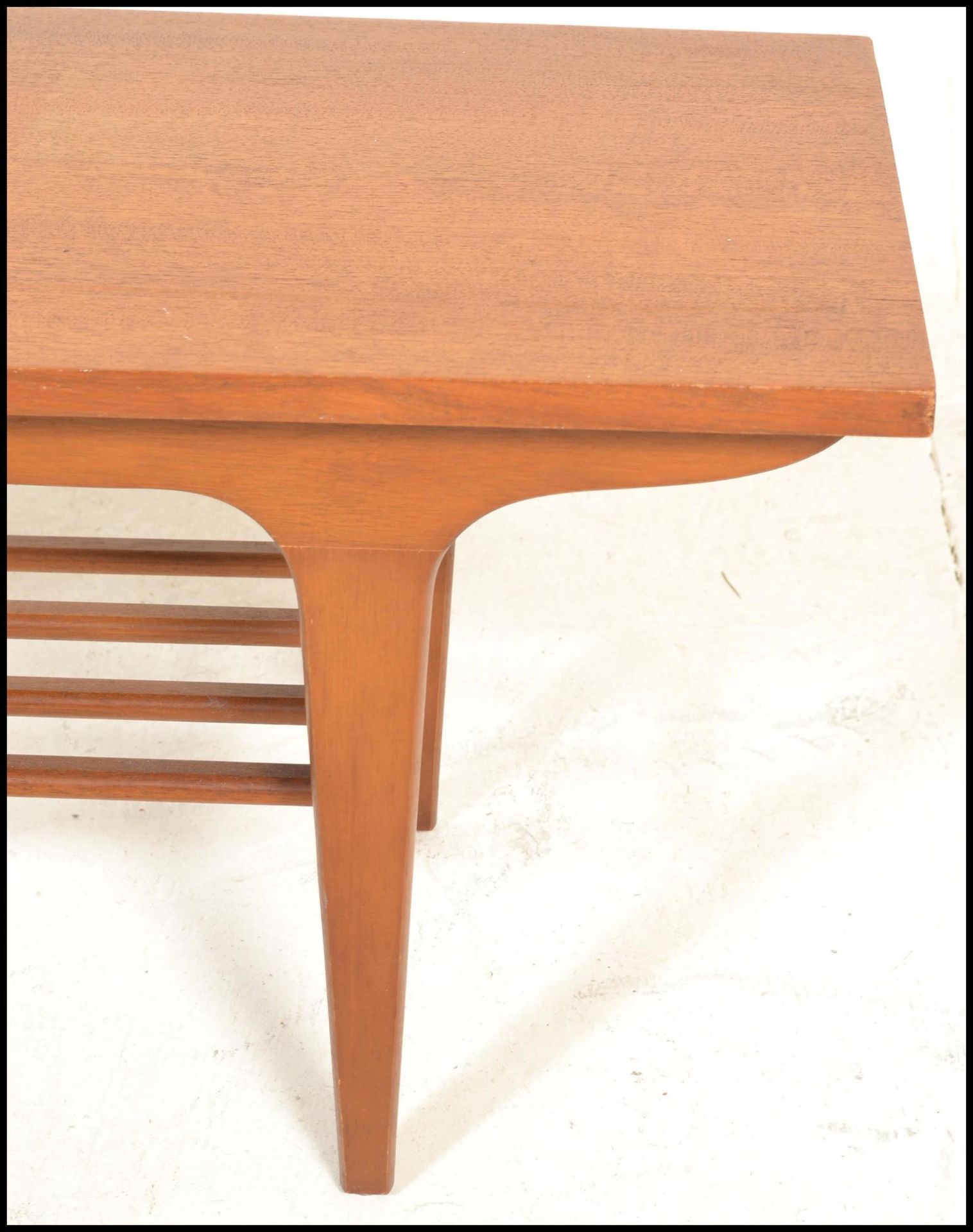 A mid century Danish influence teak wood long john coffee table being raised on tapering legs with a - Image 6 of 8