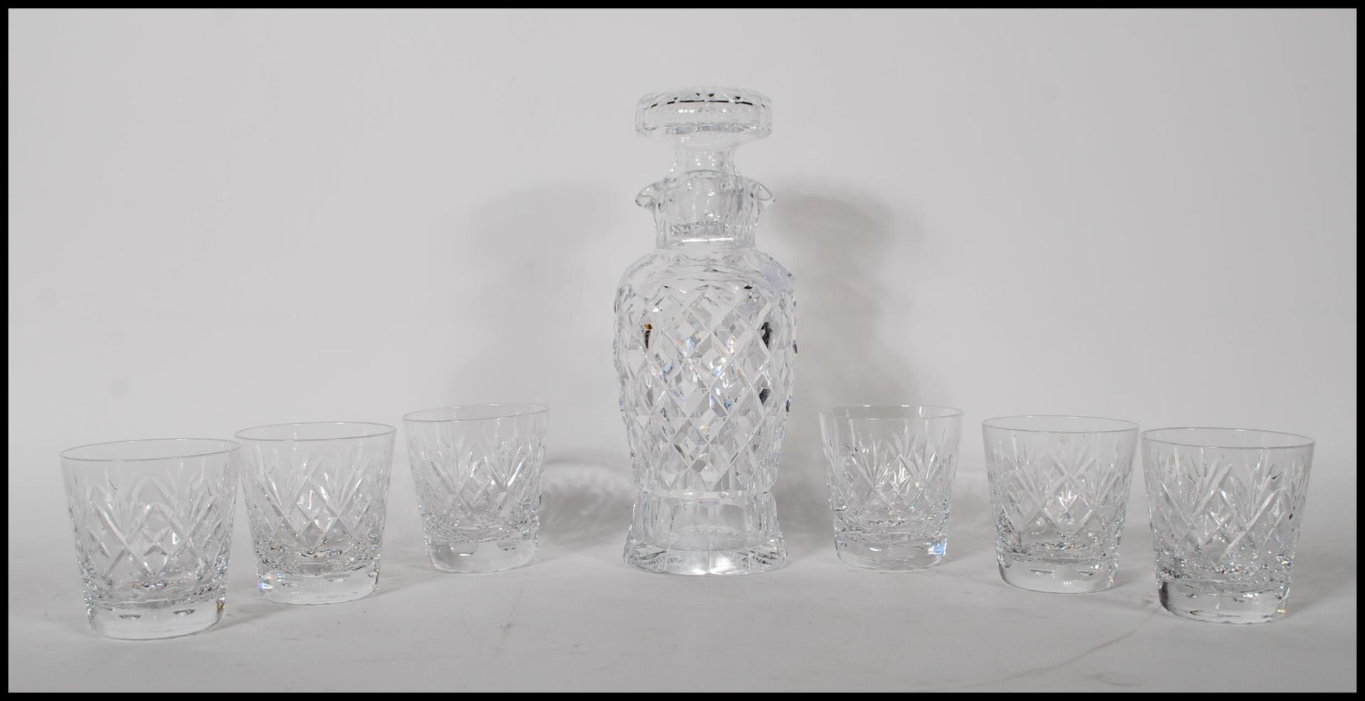 A 20th Century cut glass decanter of tapering cylindrical form having a pourer to the neck with a