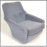 A vintage 20th Century Danish inspired arm lounge chair having blue upholstery with button back