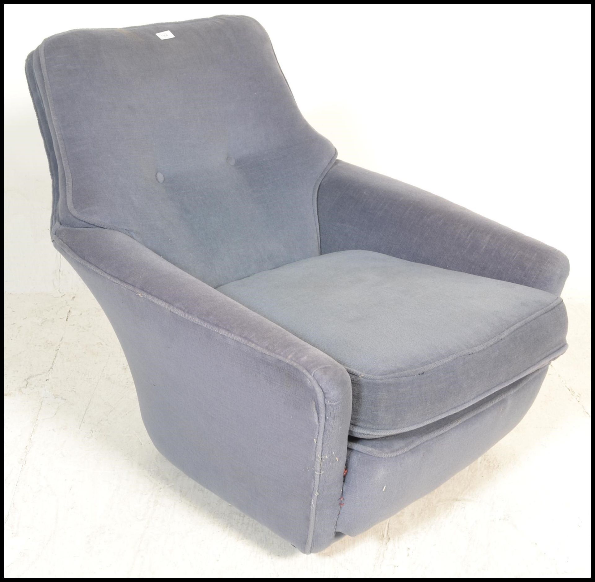 A vintage 20th Century Danish inspired arm lounge chair having blue upholstery with button back