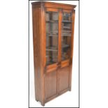 An early 20th Century Edwardian oak bookcase, glazed doors to the top with shelved interior over