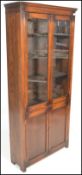 An early 20th Century Edwardian oak bookcase, glazed doors to the top with shelved interior over