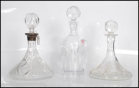 A group of three 20th Century cut glass decanters. One of typical tapering form made by Waterford '