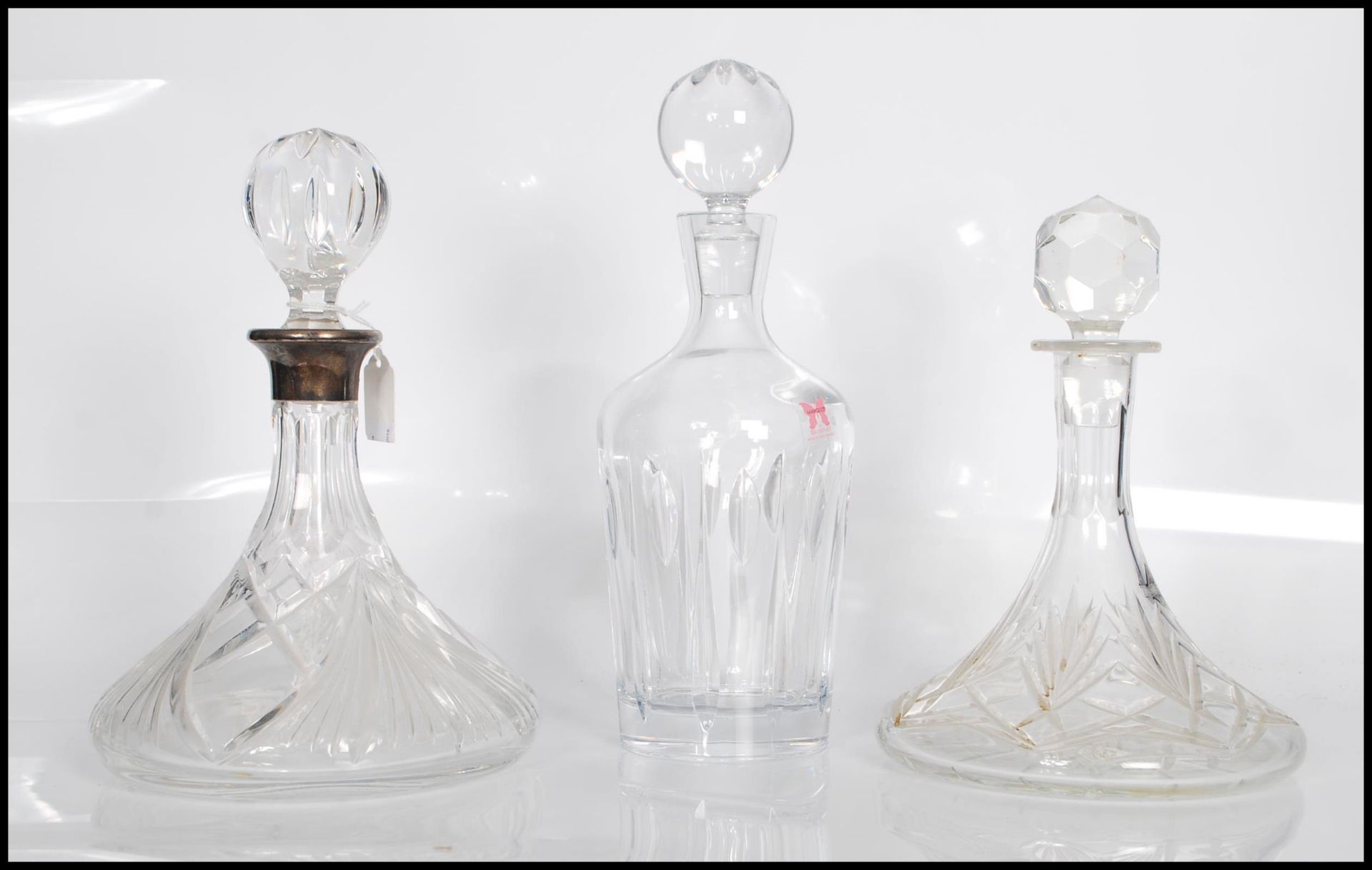 A group of three 20th Century cut glass decanters. One of typical tapering form made by Waterford '