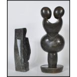 Two 20th Century soapstone sculptures of figural form, one modelled as a entwined couple raised on a