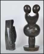 Two 20th Century soapstone sculptures of figural form, one modelled as a entwined couple raised on a
