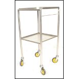 A vintage 20th Century chrome medical trolley having two tiers raised on round tubular supports with