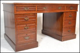 A 20th Century Georgian style mahogany veneered kneehole twin pedestal writing desk with tooled