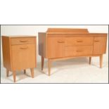 A retro 20th Century light teak wood sideboard having a back rail with a bank of two drawers to