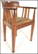 A 19th Century oak Arts and Crafts open framed captains desk / office chair in the manner of