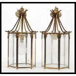 A pair of early 20th Century brass porch lantern of hexagonal form having glazed glass panels with