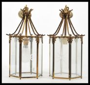 A pair of early 20th Century brass porch lantern of hexagonal form having glazed glass panels with
