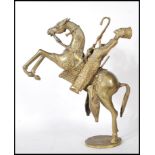 An early 20th Century African Benin style cast brass figurine of a rearing horse with a rider