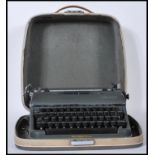 A vintage mid 20th Century Olympia typewriter in army green set within its original fitted carry