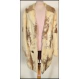 A mid 20th Century white and brown rabbit fur coat having a red silk lining.