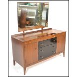 A mid century teak wood dressing table with ebonised central chest of drawers and a dressing