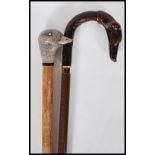 Two  20th Century walking stick canes to include a walking stick with a faux wooden handle in the
