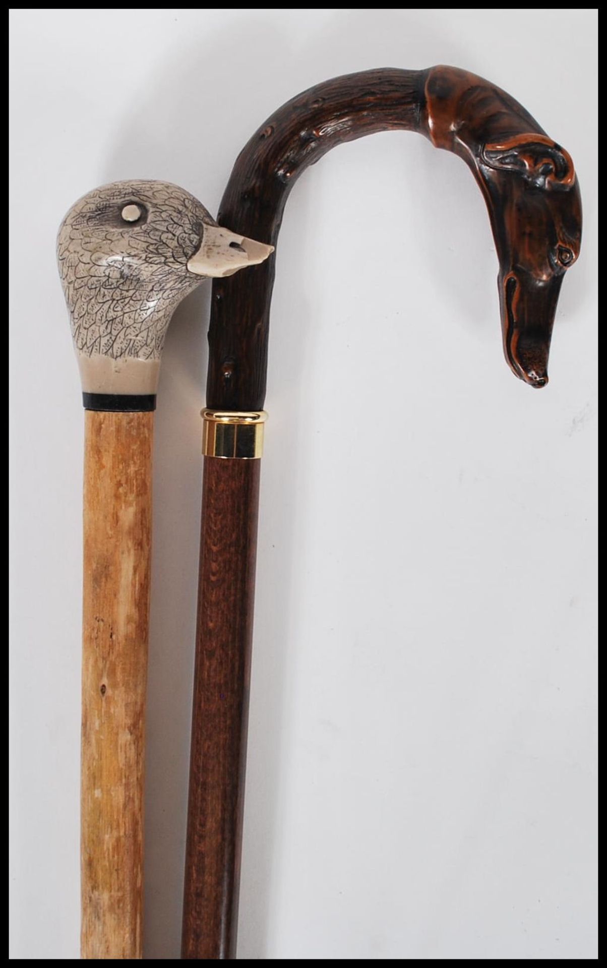 Two  20th Century walking stick canes to include a walking stick with a faux wooden handle in the
