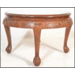 A 20th Century Chinese carved hardwood round tea table with quartetto nesting stools. The deep
