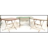 A set of retro 20th century metal folding cafe tables. Each with folding metal leg bases having