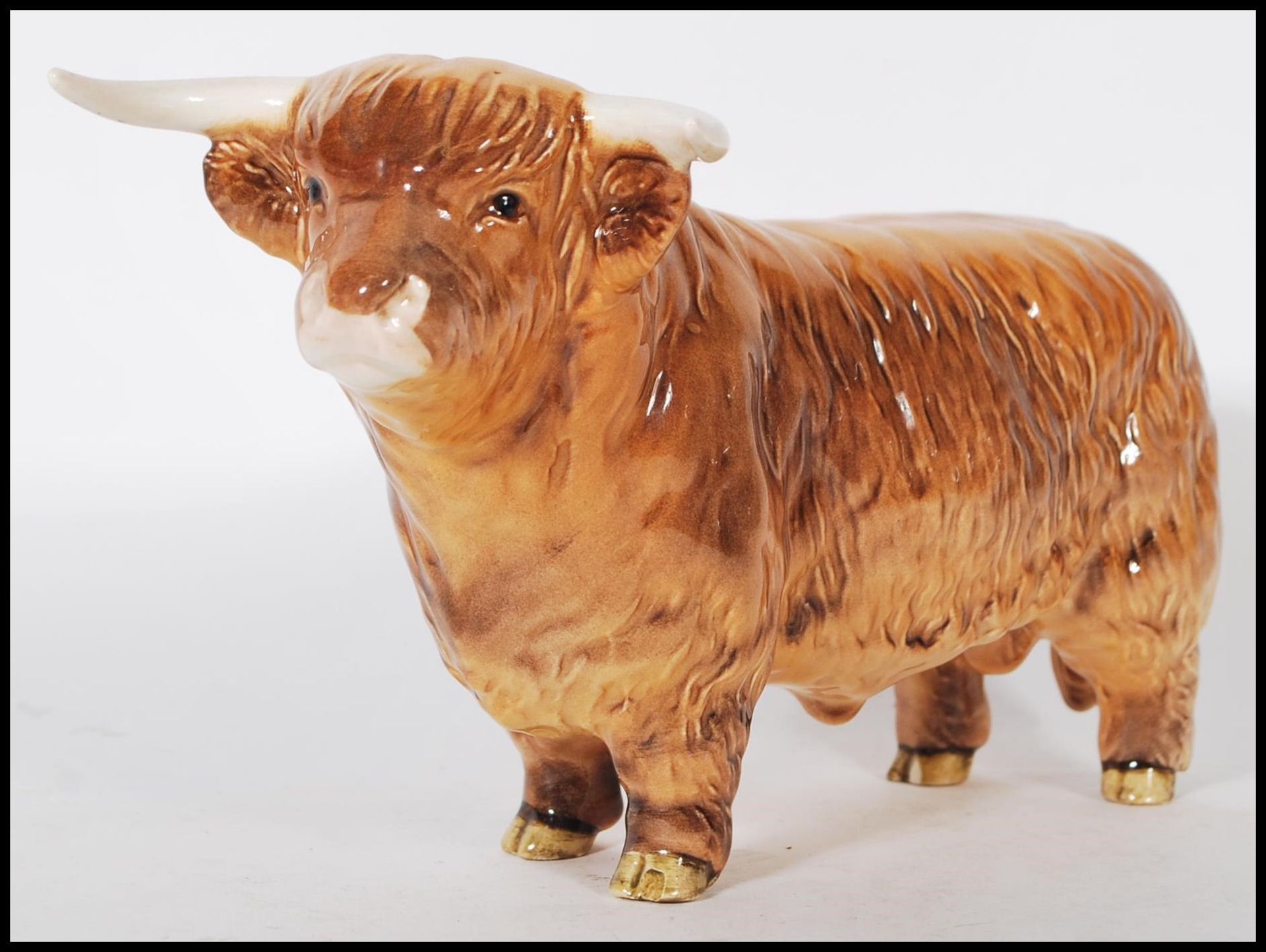 A Beswick ceramic figurine of a Highland cattle bull being stamped for Beswick, England to the foot.