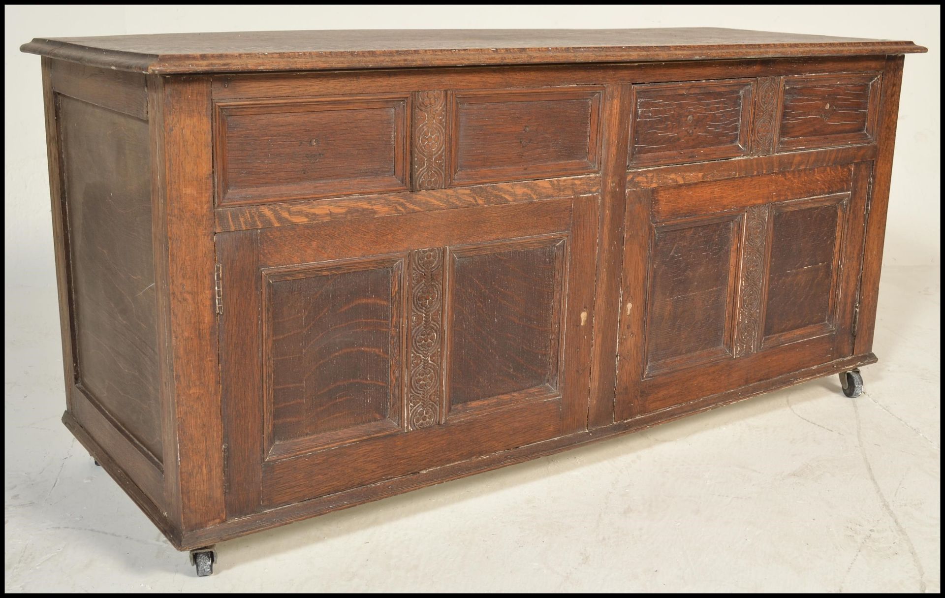 A 20th Century Jacobean revival panel oak coffer chest, panel sides and front with hinged top raised