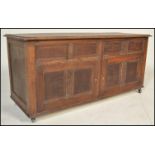 A 20th Century Jacobean revival panel oak coffer chest, panel sides and front with hinged top raised