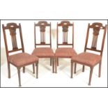 A set of four early 20th Century Arts and Crafts oak dining chairs, gcarved backrests with