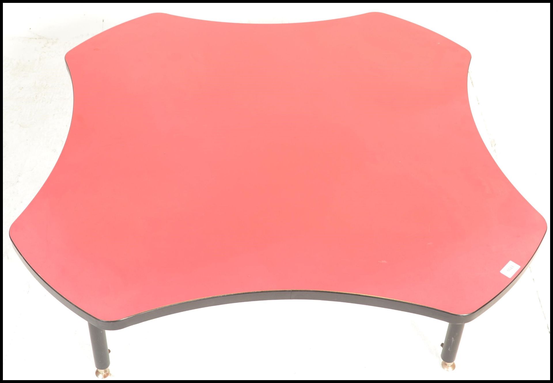 A 20th Century retro coffee table of square form having concave sides to the red top with ebonised - Bild 2 aus 4