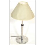 A 20th Century Art Deco style chrome table lamp raised on a circular base having a two part