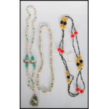 A group of 1930's Art Deco necklaces to include a long beaded bakelite flapper necklace having round