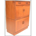 A retro 20th Century G Plan teak wood tallboy unit having a single drawer above two twin door