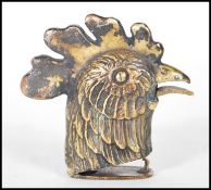 A brass cased vesta in the form of a rooster having match striker to base that opens via squeezing