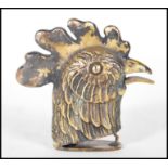 A brass cased vesta in the form of a rooster having match striker to base that opens via squeezing