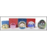 A collection of five 20th Century studio glass paperweights to include examples by Mdina, Selkirk