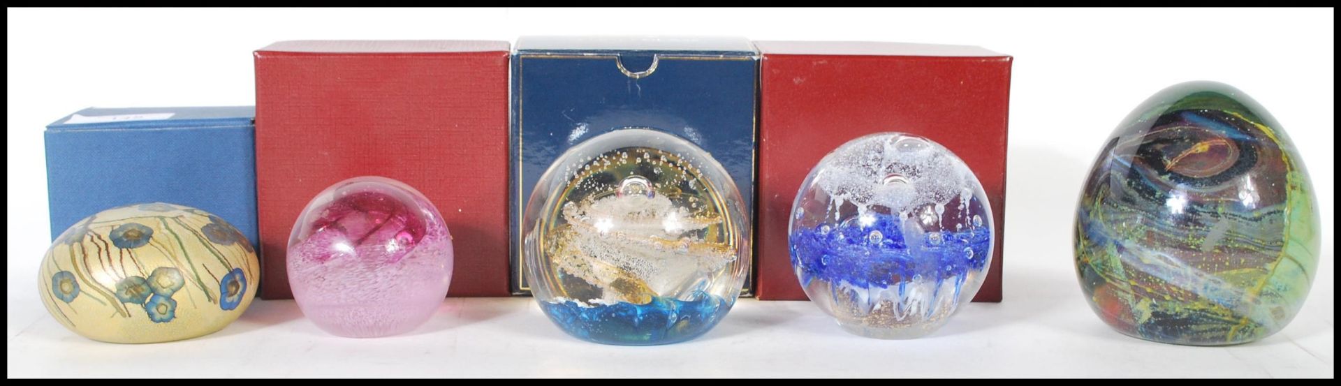 A collection of five 20th Century studio glass paperweights to include examples by Mdina, Selkirk