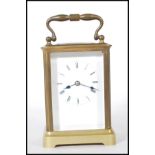 A 20th Century brass carriage clock of rectangular form having glass panels to the four sides with
