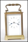 A 20th Century brass carriage clock of rectangular form having glass panels to the four sides with