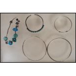 A selection of silver bracelets to include a bangle set with oval turquoise cabochons, a Rhona