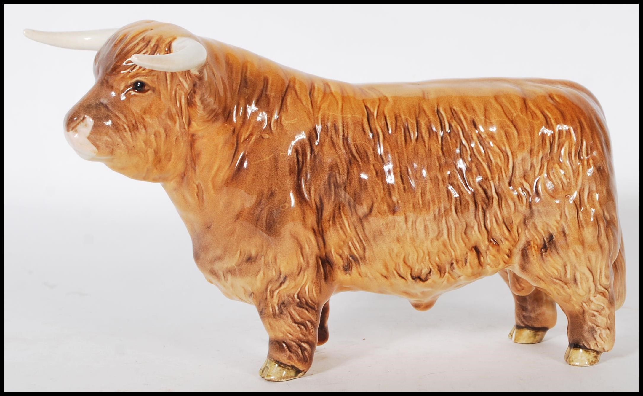 A Beswick ceramic figurine of a Highland cattle bull being stamped for Beswick, England to the foot. - Image 2 of 7