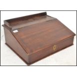 A Victorian 19th century mahogany clerks desk. The box shaped body with sloped and hinged top