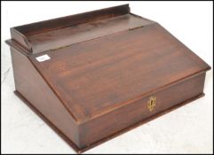 A Victorian 19th century mahogany clerks desk. The box shaped body with sloped and hinged top