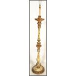 A n early to mid 20th Century Italian style painted and carved wood standard lamp, painted with