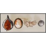 A group of four brooches to include cameo brooch depicting a neoclassical lady with a chailike