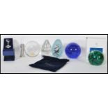 A collection of glass paperweights to include boxed Caithness in the Swirly Whirly pattern,